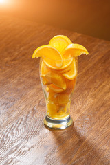 drink bar fresh background of orange slices in a glass on a wood background