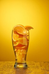 drink bar fresh composition of orange slices in a glass on a deep orange background