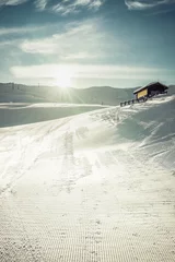 Fotobehang Ski slopes with wooden chalet, winter landscape. Vintage filter added © marchello74