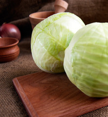 cabbage on a wooden board on a background sacking, burlap
