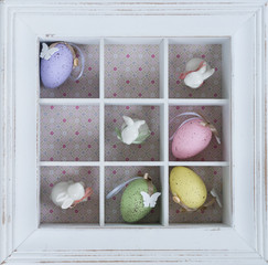 Easter tic tac toe game with eggs and rabbits in box clos eup - pastel colors and rustic style