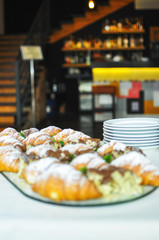Assortment of fresh pastry on table in buffet. Croissants and cakes