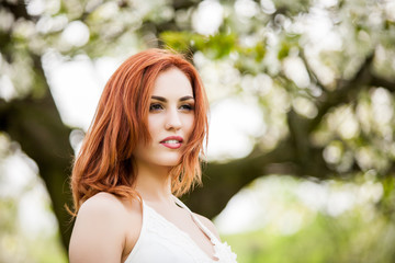 Naklejka premium Beautiful redhead woman outdoor photo