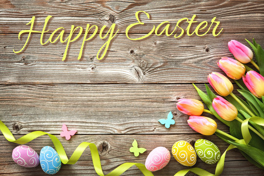 Easter background with colorful eggs and spring tulips