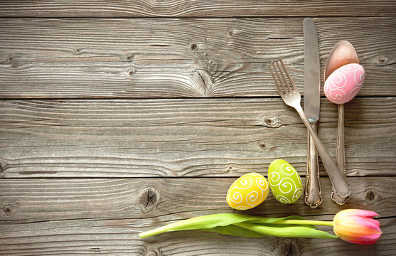 Easter table setting with spring tulips and cutlery