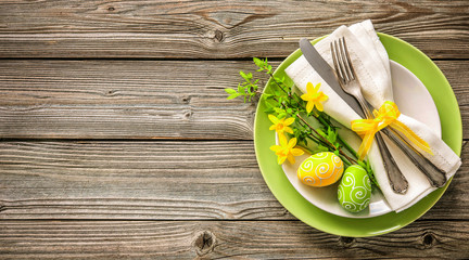 Easter table setting with daffodil and cutlery