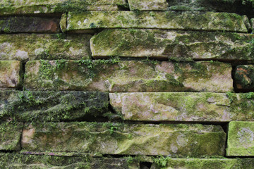 Old stone wall covered with moss