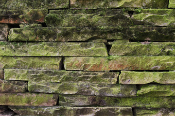 Old stone wall covered with moss