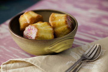 Traditional Polish babka - Easter mini cakes with icing and pink sprinkles. 