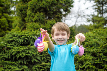Different color Easter Eggs in a child's hands- egg hunt