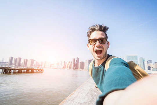 Happy tourist caucasian man having fun taking a selfie at New York city