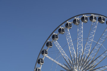 Ferris wheel before blue sky, partial view
