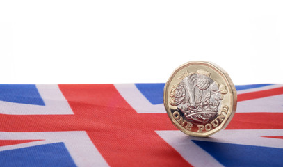 One pound coin on union jack flag, 2017 is a crucial year for the UK as brexit crisis and triggering article 50 ,  britain seeks independence from the EU.,  coincides with a new pound coin