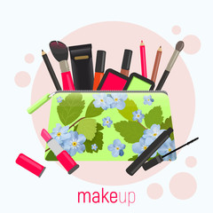 Cosmetic bag with a pattern of blue flowers. Cosmetic bag with tools for professional make-up: lipstick, mascara, eyeshadow and cosmetic brush.