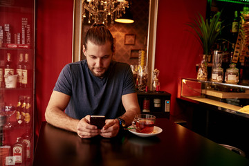 Handsome friendly guy in a bar