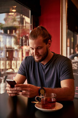 Smiling young man in a bar