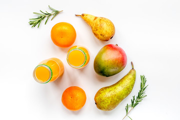 bottles of smoothie with fruits on white table top view