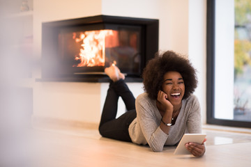 black women using tablet computer on the floor