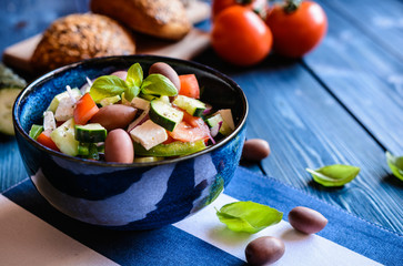 Fototapeta na wymiar Horiatiki salata - traditional Greek salad made of tomato, cucumber, Feta cheese, Kalamata olives, bell bepper and onion