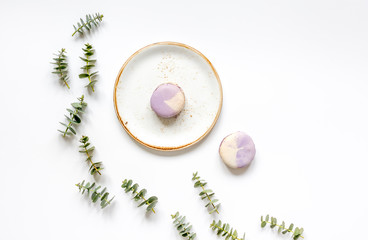 Spring design with macaroons and eucalyptus on white background top view mockup