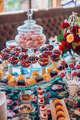 Delicious sweets on candy buffet. Lot of colorful desserts on table.