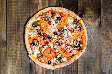 Delicious italian pizza on wooden table, close-up.