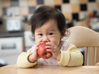 baby girl eating apple