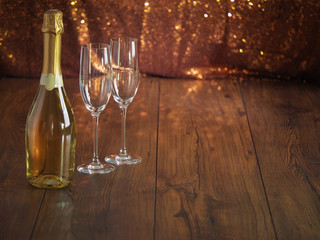 Bottle of champagne and two champagne glasses.