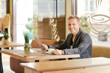Portrait of a young man in a cafe