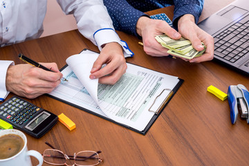 two men calculates income tax form. tax form concept.