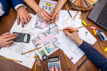 two people talking about  architectural project with engineering tools on workplace. Construction concept.