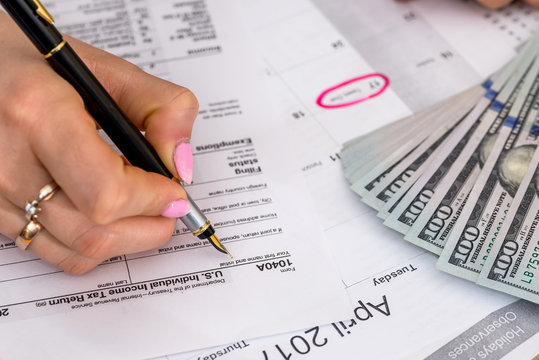 Woman Filing US Tax Form. Annual Budget.