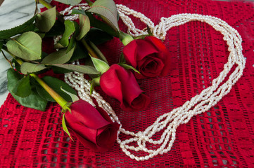 Three Red Roses and Pearls in the sharpe of a heart