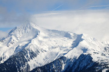 Fototapeta na wymiar Mountain piek with clouds and snow