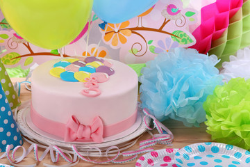Birthday pink cake and balloons on party or reception