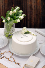 first holy communion cake on wooden background