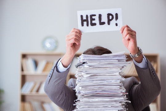 Businessman busy with paperwork in office