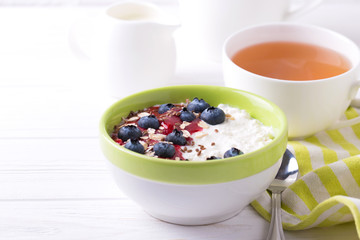 Oatmeal with blueberries, jam and yogurt with tea