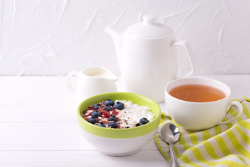 Oatmeal with blueberries, jam and yogurt with tea