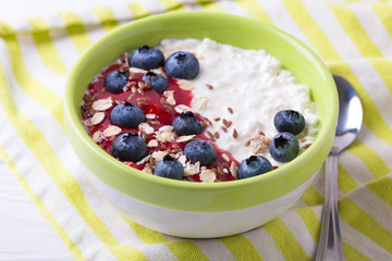 Oatmeal with blueberries, raspberry jam, flax seeds and yogurt