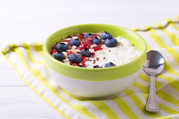 Oatmeal with blueberries, raspberry jam, flax seeds and yogurt