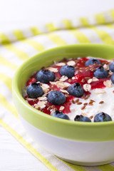 Oatmeal with blueberries, raspberry jam, flax seeds and yogurt