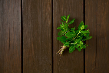 bunch of mint leaves on wooden surface