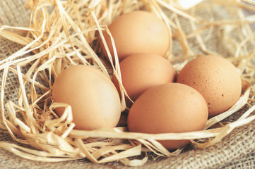 Eggs over jute sack background. Happy easter.