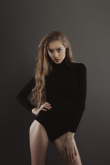 Fototapeta premium Beautiful blonde woman posing for model tests at grey studio background