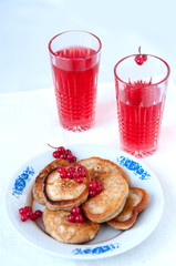 Pancakes with berries red currant and juice