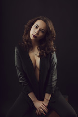 Sexy brunette model with curly hair wearing leather jacket