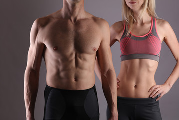 Fototapeta na wymiar Fit couple, strong muscular man and slim woman . Sport, fitness ,workout concept.