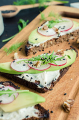 Sandwiches of rye bread with avocado and goat cheese