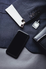 Men's accessories - smartphone, cufflinks, shirt, pen, jacket.